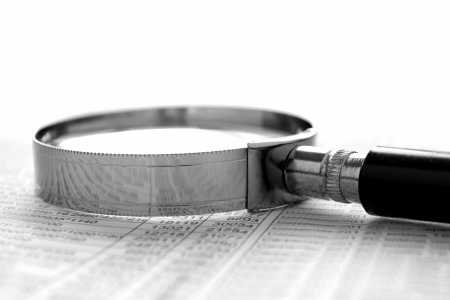 chart and a magnifying glass on the table, the tools for the study of documents