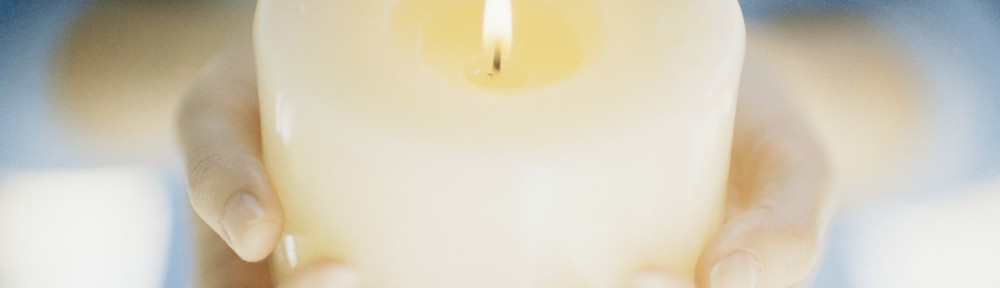 Hands Holding a Lit Candle