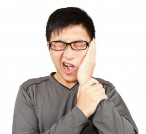 Man with pain expression on white