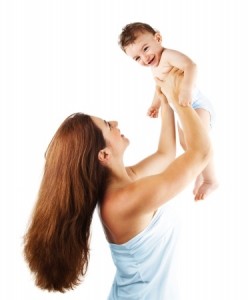 Mother playing with baby boy, happy family having fun indoor