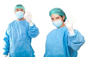 Surgeons team showing okay hand sign with the concept of successful surgery isolated on white background