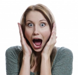 Close-up of a young woman looking excited; isolated on white