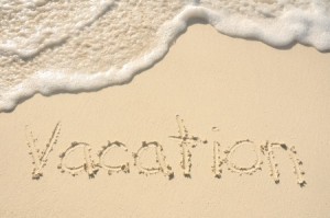 The Word Vacation Written in the Sand on a Beach