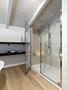 shower cubicle in a modern bathroom on attic with wood ceiling nd parquet