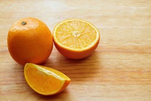 42022321 - orange, half of orange and orange lobule on the wooden table