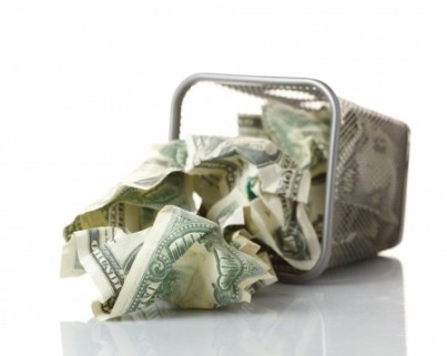 Money in basket. Isolated over white