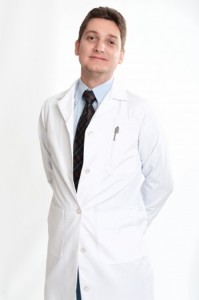 Smiling man on his thirties on lab coat and tie