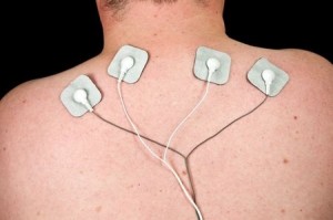photo male with acute neck pain, electrodes to tens unit
