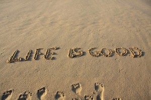 Life is good message written on a sandy beach