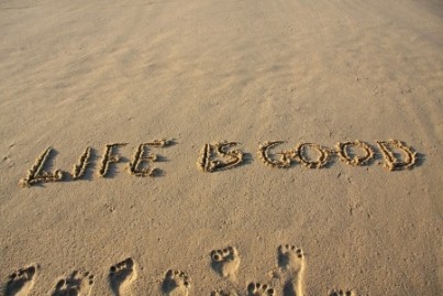 Life is good message written on a sandy beach