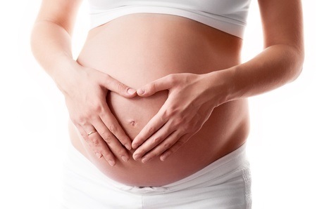 pregnant woman with her hands on her belly, isolated against white background