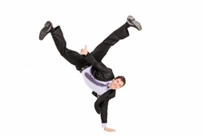 Businessman standing on one hand