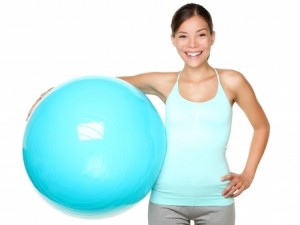 Fitness exercise woman holding pilates ball ready for exercising.