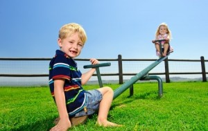 Kids playing at the see-saw in the playground