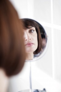 Woman Looking At Herself In The Mirror