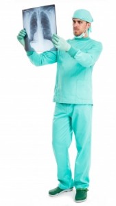Full length portrait of a surgeon examining a radiography
