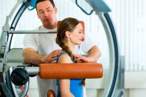 Patient at the physiotherapy making physical exercises with her therapist