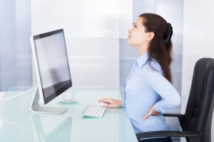 Portrait Of Young Businesswoman Suffering From Back Pain