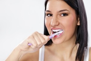 Pretty girl brushing her teeth