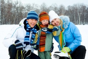 happy young parents going ice skating with their son