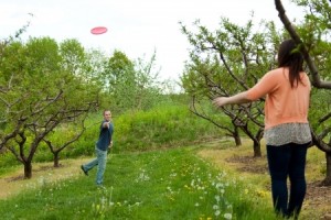A couple plays with a frisbee together outdoors