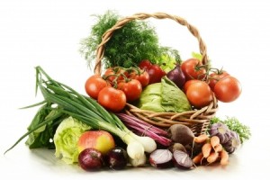 Composition with raw vegetables and wicker basket isolated on white