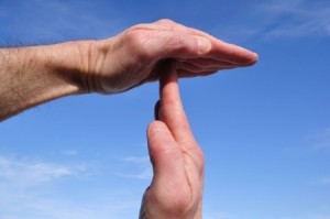 Doing Time Out Signal with Hands Against a Blue Sky