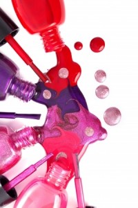 Image of bright-colored nail polish spilling from bottles