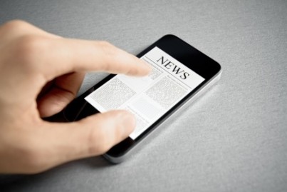 Man hand touch screen with news on contemporary mobile phone