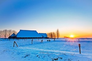 Sunset of farm in white winter landscape