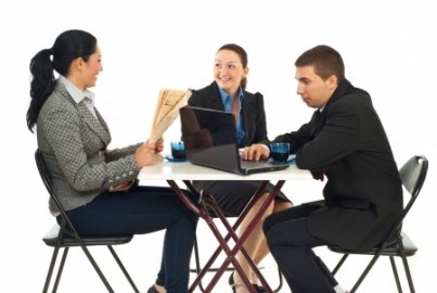 Threee business people sitting on chairs