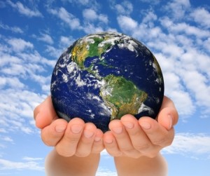 Woman holding globe on her hands, South and North America Earth image courtesy of NASA