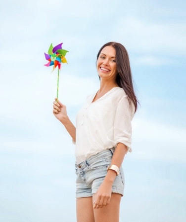 girl with windmill toy on the beach