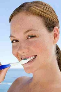 woman brushing her teeth