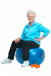 Attractive senior woman at health club, doing exercises