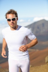Male runner jogging outside in mountain landscape