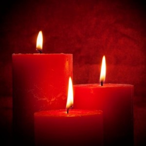 Three candles with red background