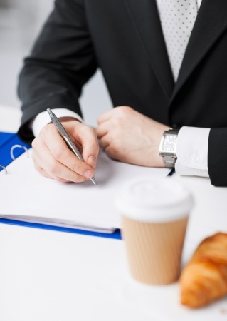businessman on his coffee break making notes