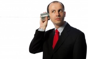 Man listening through an oldschool can phone