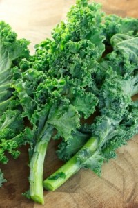 Fresh kale on wooden cutting board