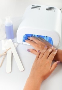 Hands with uv lamp for nails
