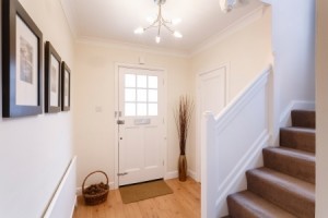 Home interior showing hallway and carpeted stairs