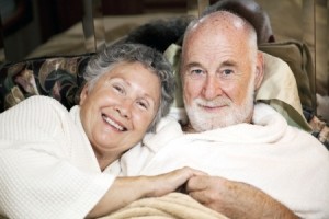 Portrait of loving senior couple in bed together