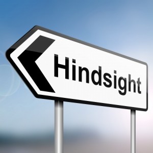 illustration depicting a sign post with directional arrow containing a hindsight concept Blurred background
