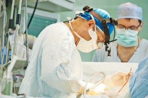 surgeon in uniform perform operation on a patient at cardiac surgery clinic