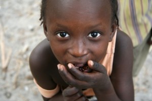 Island of Carabane,Casamance,Senegal - February 18,2007  Girl on the island of Carabane posing while carrying food to their mouths