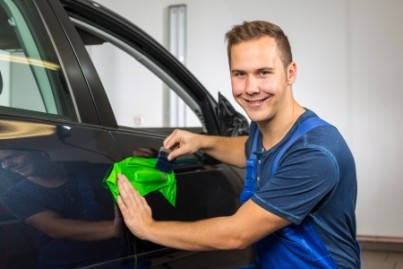 car wrapping professional wrapping car door handle in colorful foil or film using a squeegee
