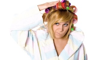 closeup portrait of funny housewife with curlers on white background