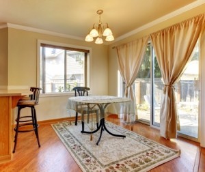 lining room area with doors and window and simple round table and hardwood floor