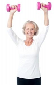 Senior lady exercising happily with dumbbells